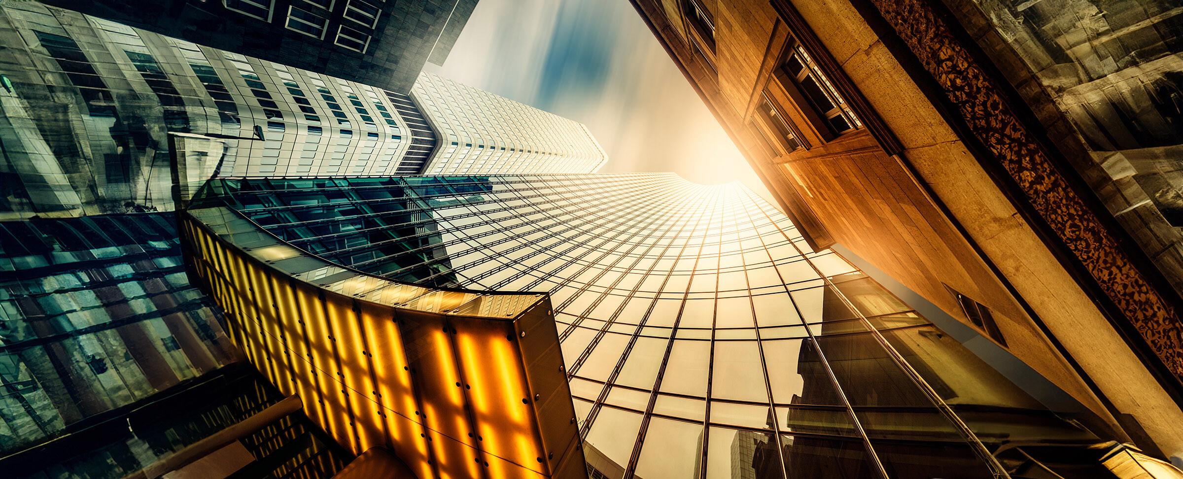 Looking up at the sky between skyscrapers